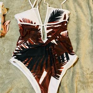 A beautiful tropical one peice bathing suit size large it’s strappy & cute